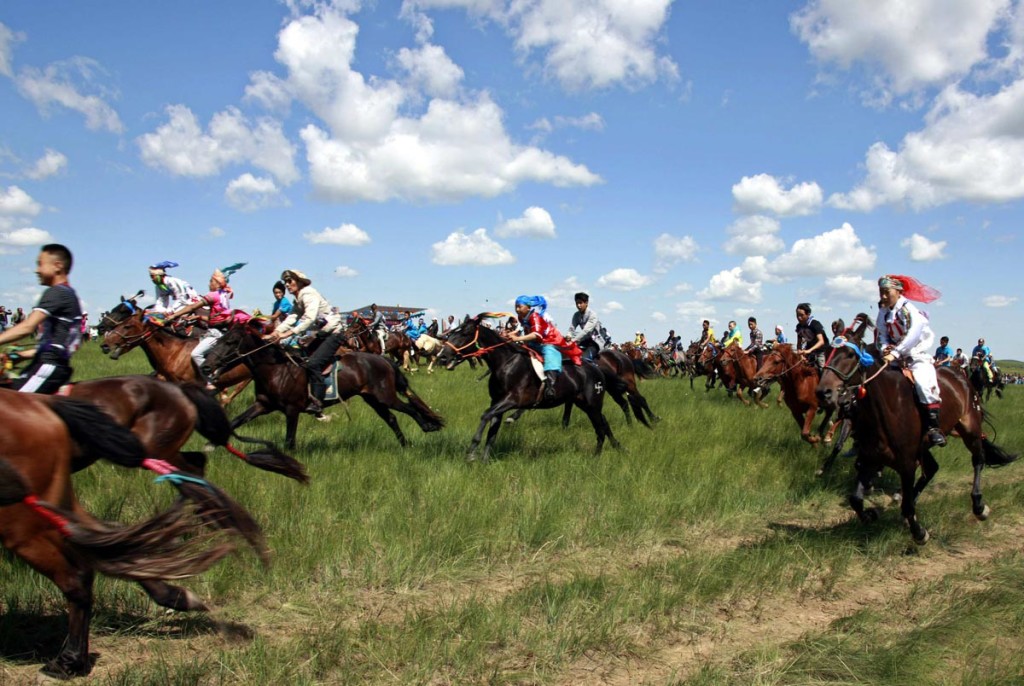 Herdsmen ride during a horse race in Xilin Gol League